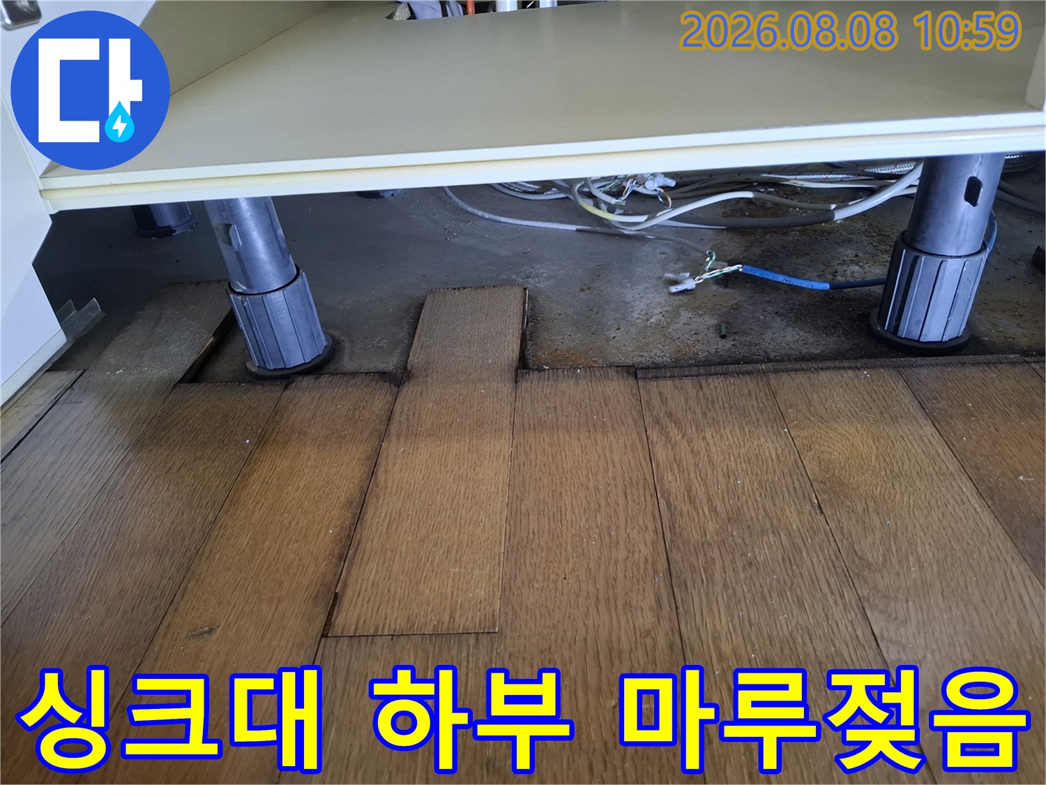 변색된 싱크대 다리 밑의 마루 판재 사진
