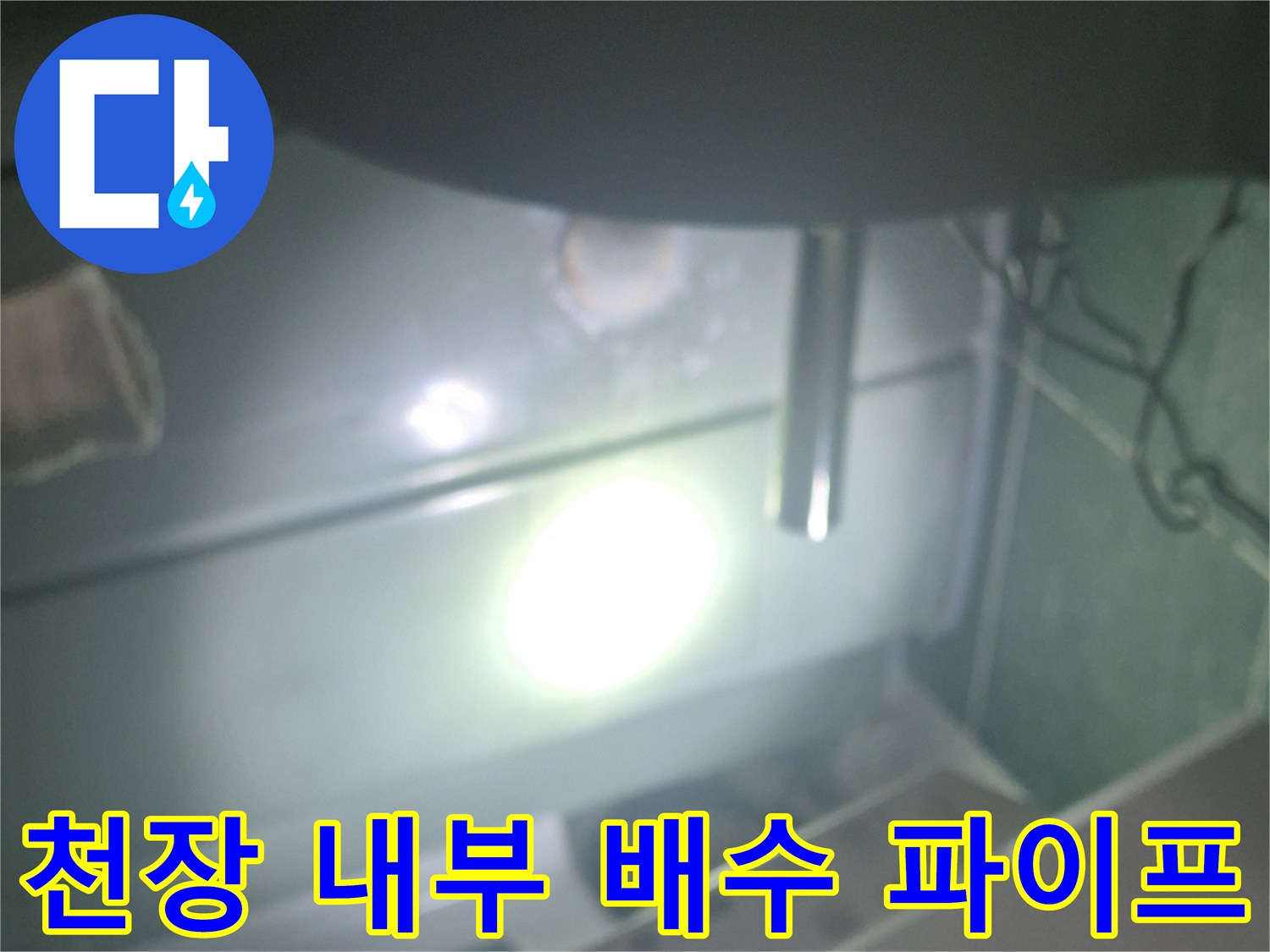 화장실 점검구 안쪽의 젖어 있는 배관 부위 촬영