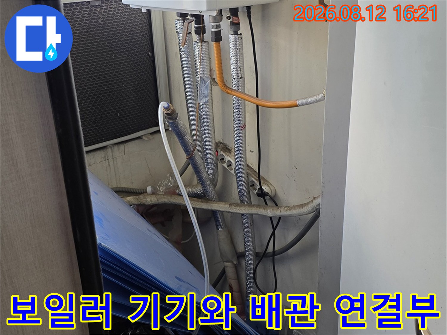 흰색 보일러 본체에서 뻗어 나온 여러 가닥의 은색 주름관-천장 내부 모습