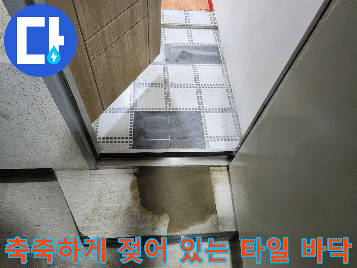 물기가 스며들어 어두워진 화장실 입구 바닥면