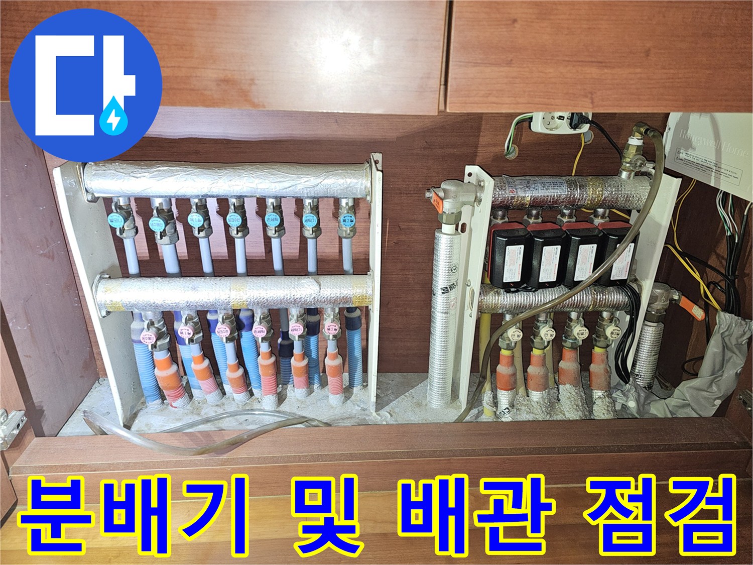 싱크대 하단 분배기 밸브와 보온재로 마감된 배관 구조