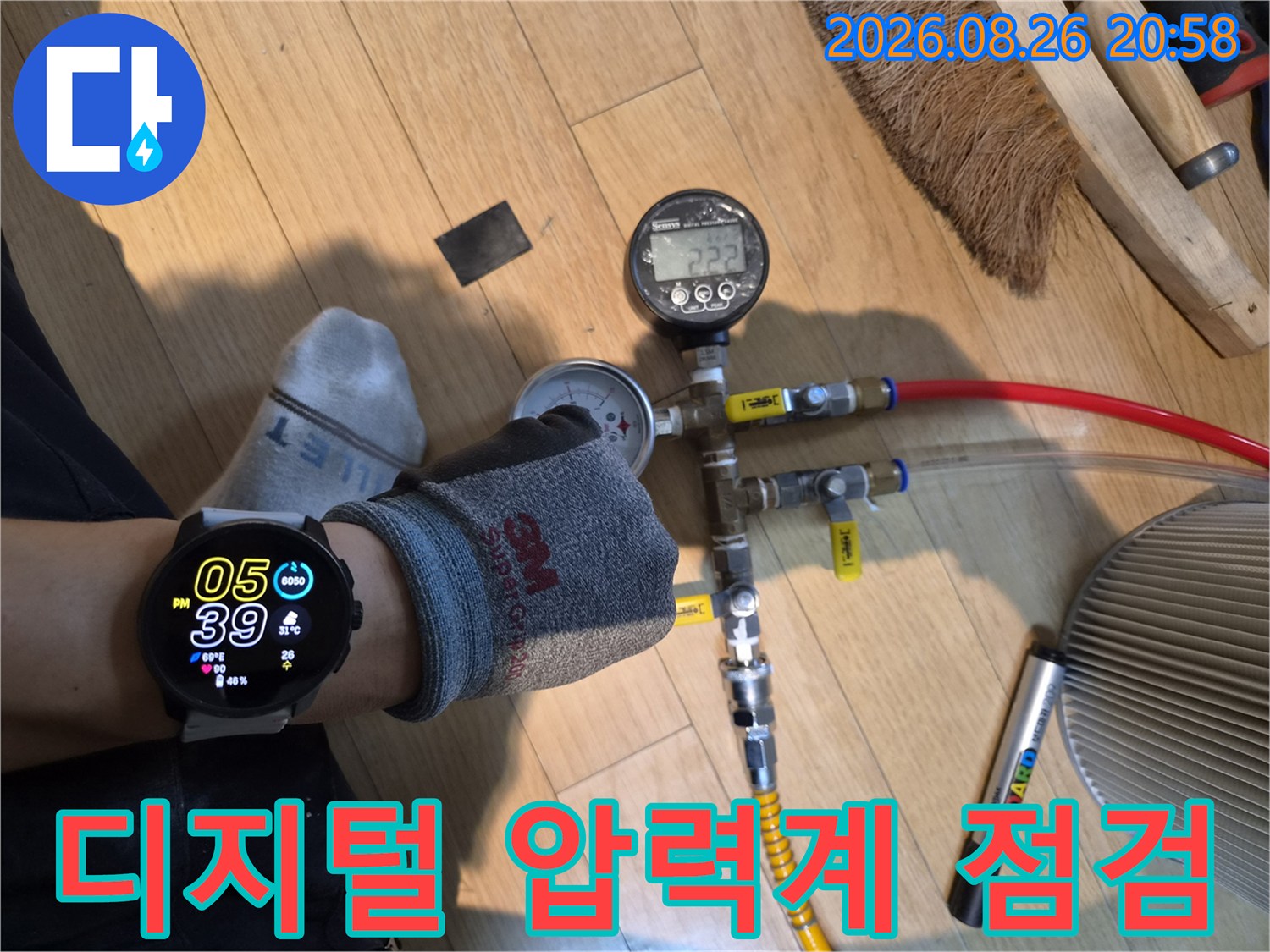 배관 연결 부위에 장비를 설치하여 수압을 체크하는 현장 사진입니다.