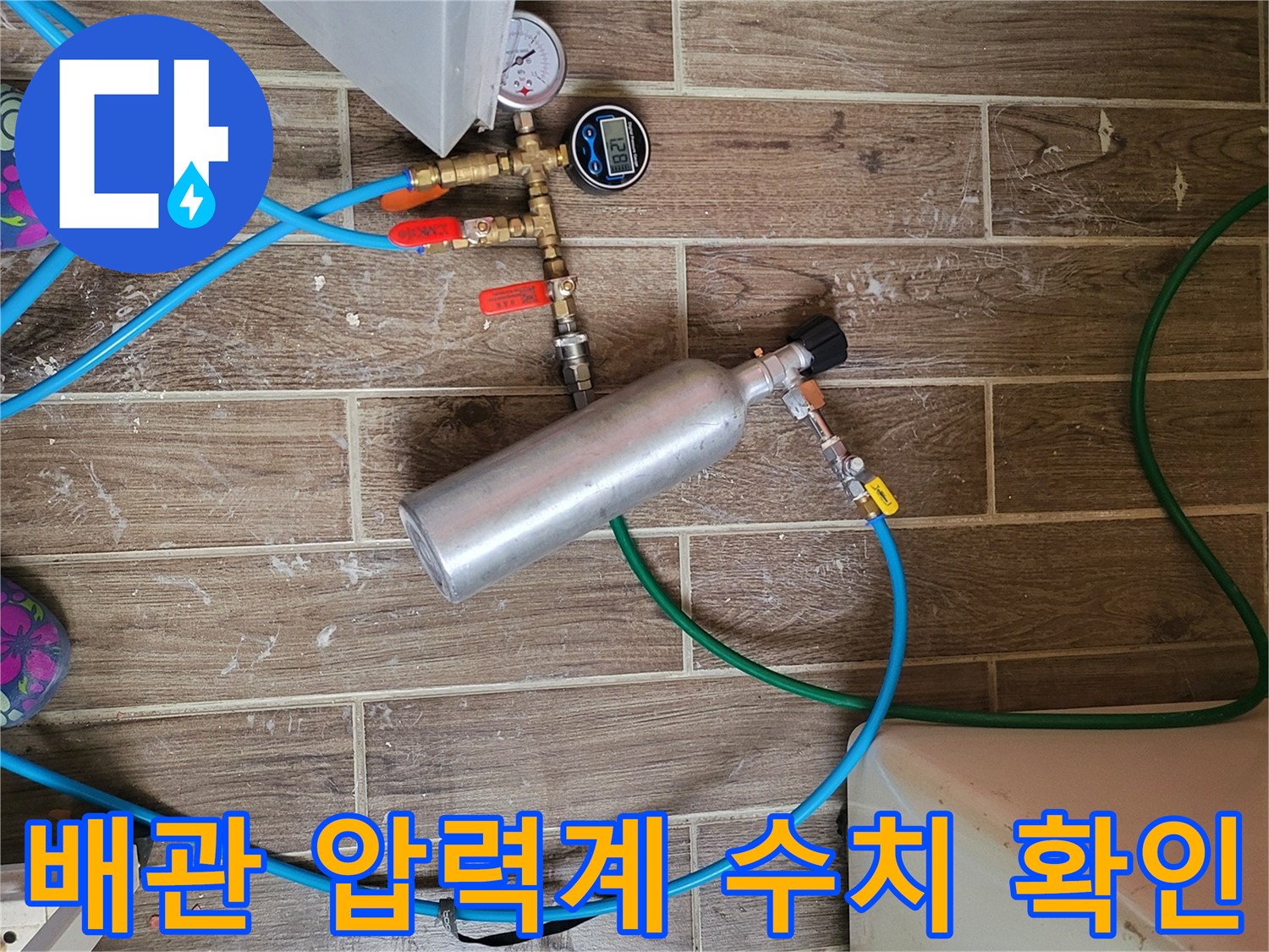 수도 배관의 압력을 측정하고 있는 게이지와 연결 호스 세트