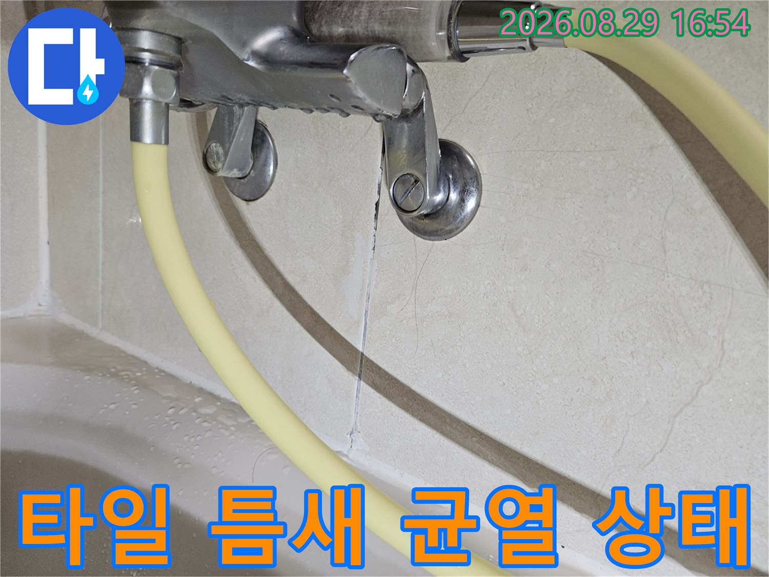 배관 연결 부위 근처의 타일 사이 균열을 상세히 촬영한 이미지입니다.