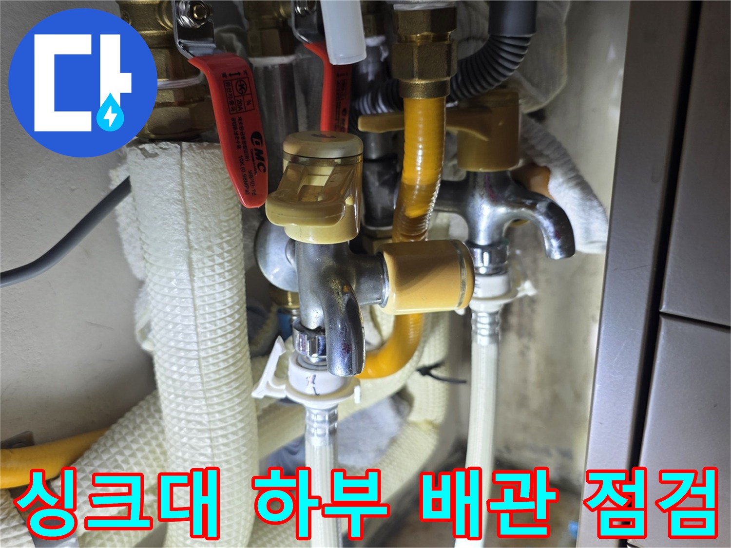 주방 싱크대 아래 수도 밸브와 배관 연결 상태 촬영
