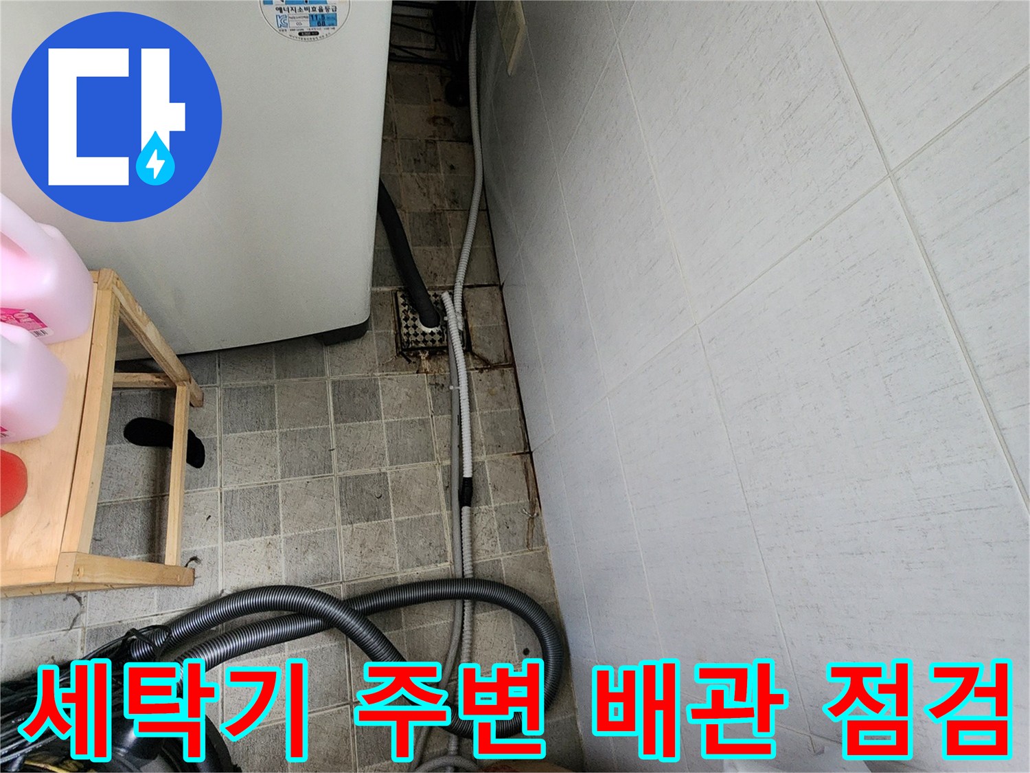 세탁기 옆 화장실 벽면의 노출된 배관과 연결 자재 확인 사진