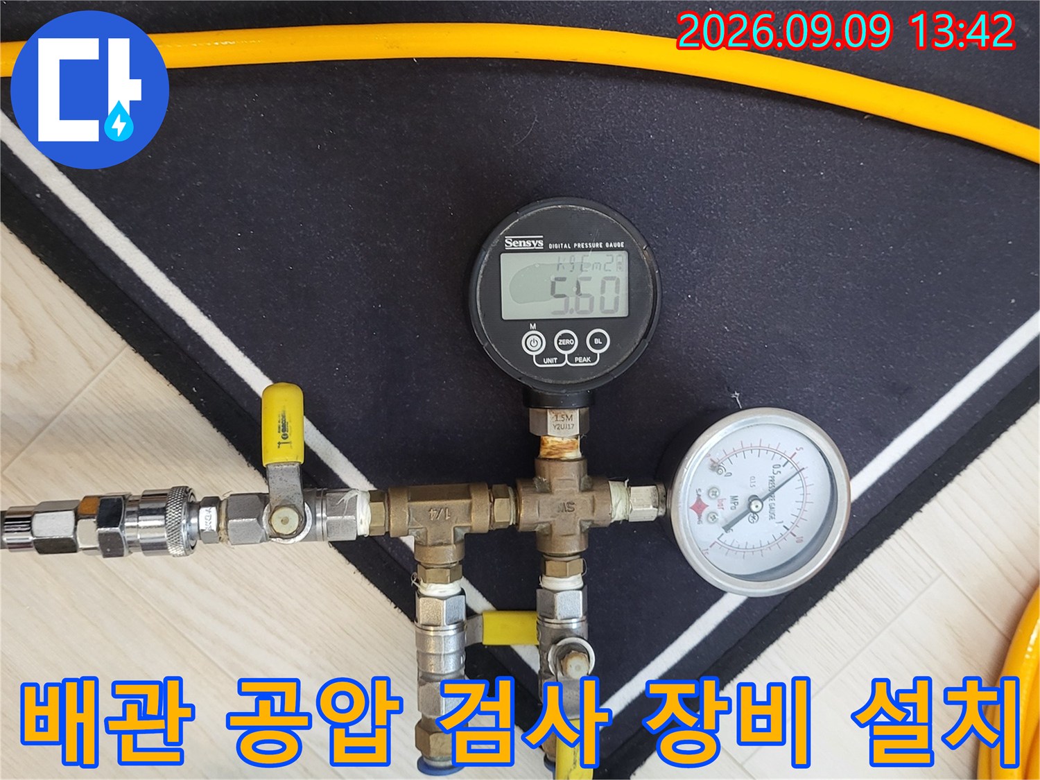 보일러 하단 배관에 연결된 압력 측정용 게이지와 호스