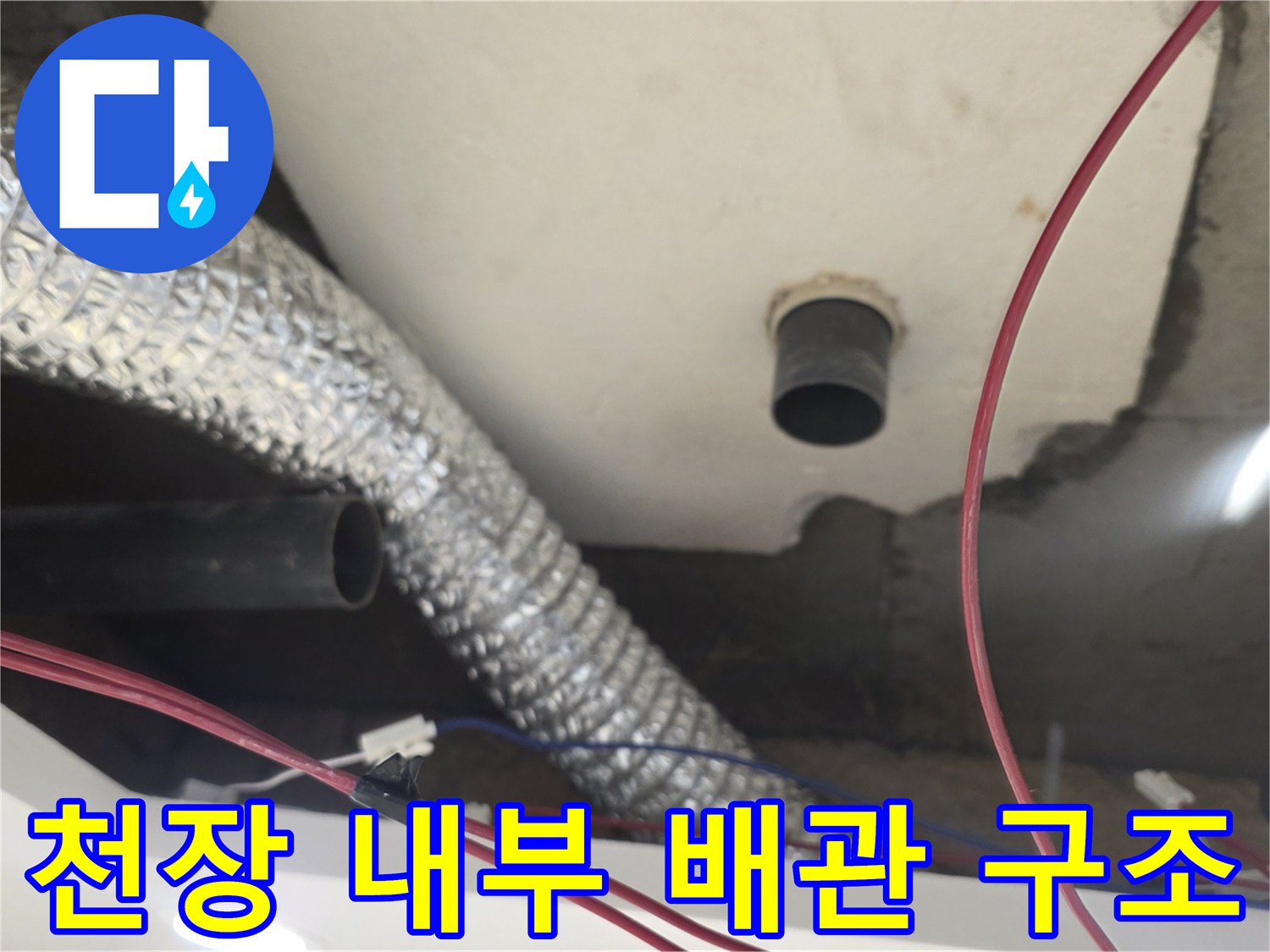 은박 보온재로 감싸진 덕트와 검정색 PVC 파이프의 천장 모습