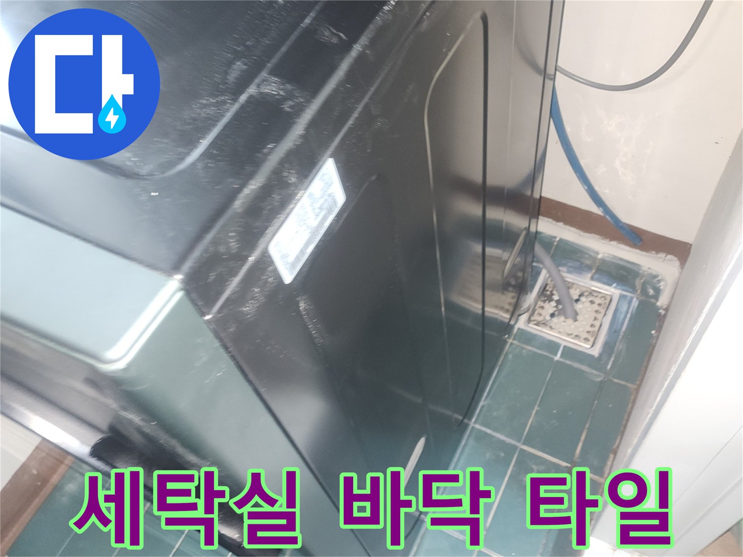 세탁기 주변의 젖은 듯한 타일 상태를 보여주는 사진입니다.